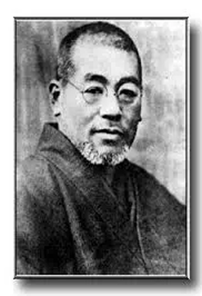 Black and white portrait of an elderly man with glasses and a beard.